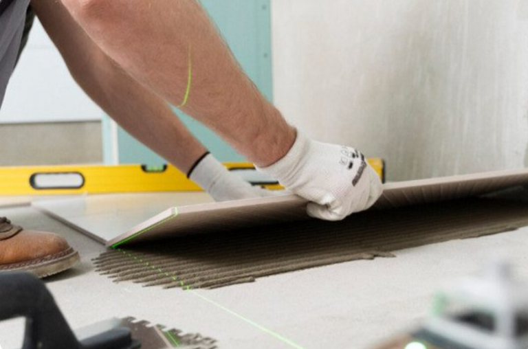 man installing waterproof bathroom floorng