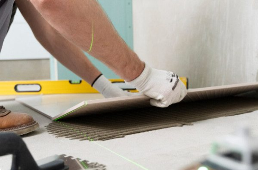 man installing waterproof bathroom floorng